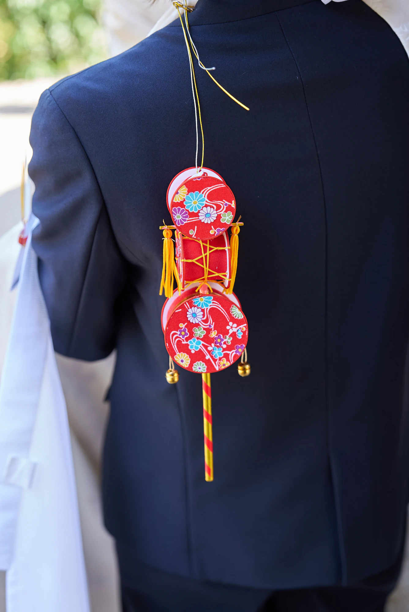 祝い着に結ばれたでんでん太鼓とお守り
